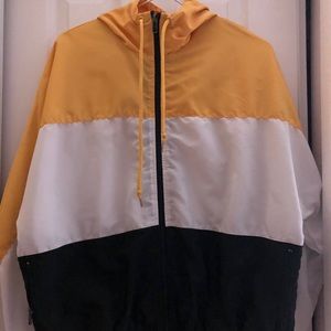 yellow, white, black windbreaker